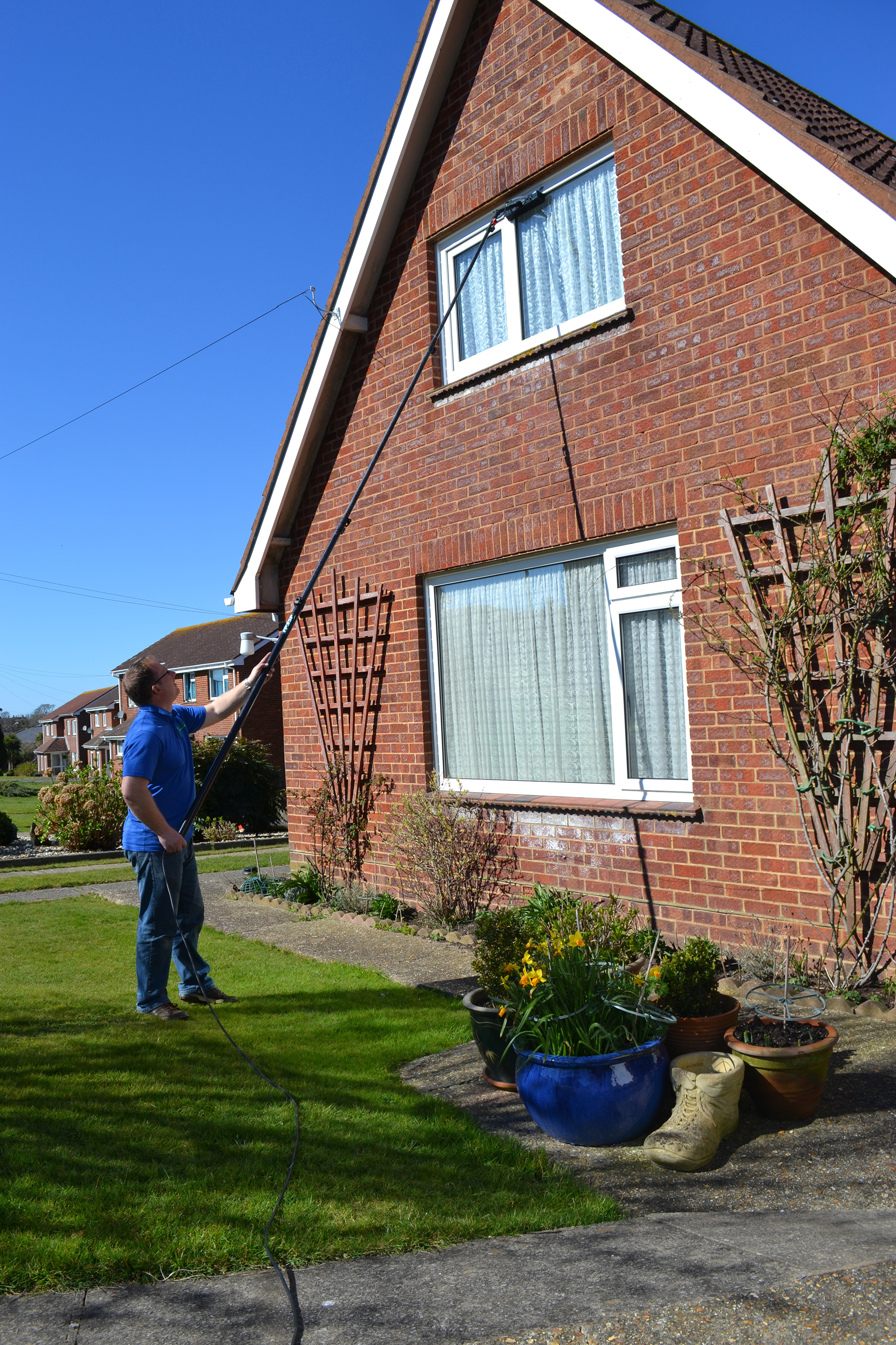 David Roberts washing upstairs windows with extendable wash brush